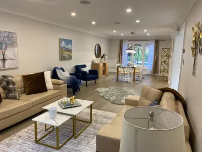 a living room with a couch and a table at 6 Bedroom Luxury House with a Bright Sunroom in Mississauga
