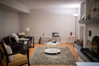 a living room with a couch and a fireplace at 6 Bedroom Luxury House with a Bright Sunroom in Mississauga