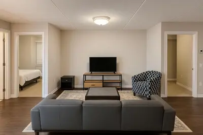 a living room with a couch and a tv at 2 Bedroom Condo in Milton in Milton