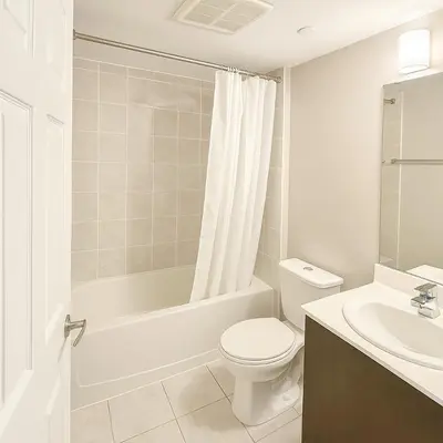 a bathroom with a toilet and a tub and a sink at 2 Bedroom Condo in Milton in Milton