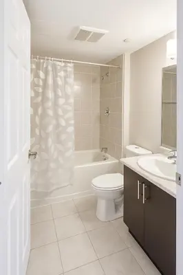 a bathroom with a toilet and a tub and a sink at 2 Bedroom Condo in Milton in Milton