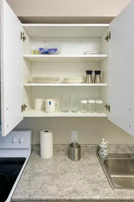 a kitchen with white shelves and a sink at 2 Bedroom Condo in Milton in Milton