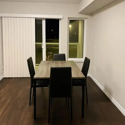 a dining room with a table and chairs at 2 Bedroom Condo in Milton in Milton
