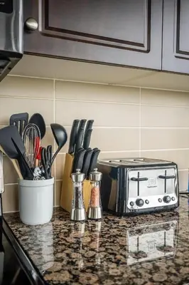a kitchen counter top with a toaster and some knives at Panorama Luxe Suites - Prime Downtown Location in Toronto