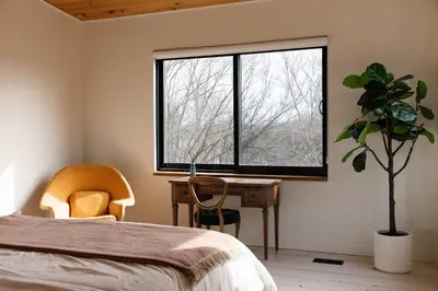 a bedroom with a bed and a desk and a window at Willow Creek - Modern Sunlit Bungalow in Hillier