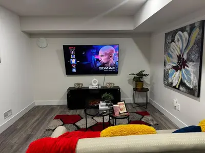 a living room with a flat screen tv on the wall at Gateway to Serenity-Welcome home in London