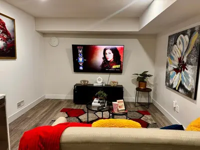 a living room with a bed and a flat screen tv at Gateway to Serenity-Welcome home in London