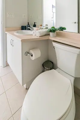 a bathroom with a white toilet and a sink at Luxury CN Tower Suites - Save on Monthly Stays in Toronto