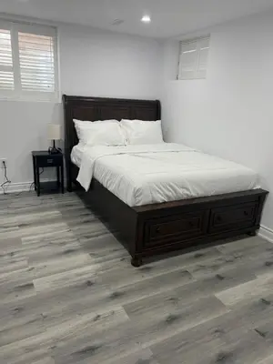 a bedroom with a large bed with white sheets at Welcome to Skies Abode in Paris