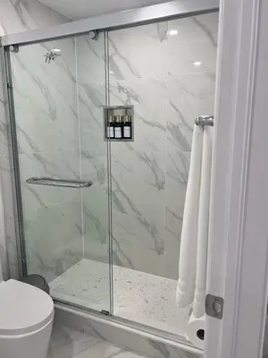 a shower with a glass door in a bathroom at Welcome to Skies Abode in Paris
