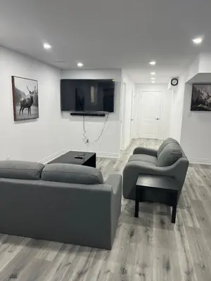 a living room with two couches and a flat screen tv at Welcome to Skies Abode in Paris