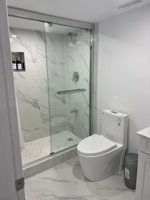 a white bathroom with a shower and a toilet at Welcome to Skies Abode in Paris