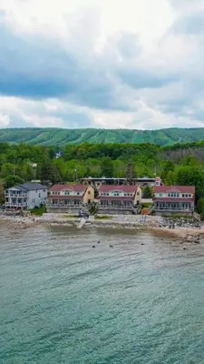 a group of buildings on a beach next to the water at Blue View Chalets in Blue Mountains