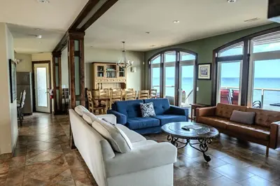 a living room with blue couches and a table at Blue View Chalets in Blue Mountains