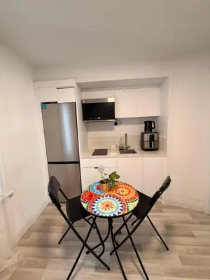 a small kitchen with a table and two chairs at Bright 2bedroom apartment in Hamilton