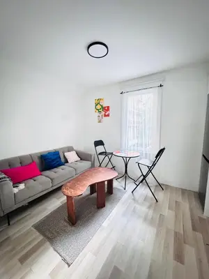 a living room with a couch and a table at Bright 2bedroom apartment in Hamilton