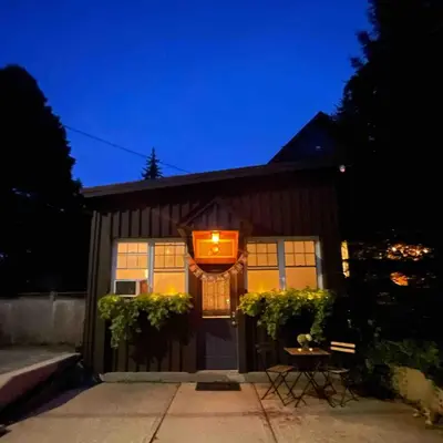 a house with a sign on the front of it at Cozy Coach House in Kitchener