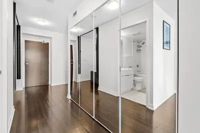a bathroom with a toilet and a glass wall at Apartment in Downtown Toronto in Toronto
