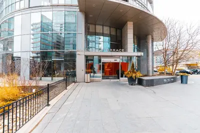 a large glass building with a red door at Apartment in Downtown Toronto in Toronto