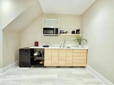 a kitchen with a sink and a microwave at Downtown Toronto Apartments in Toronto