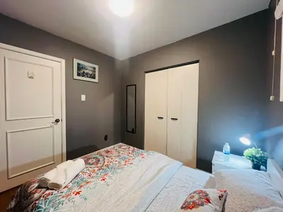 a bedroom with a bed and a white door at Cozy Stay, Self Check-In with Parking available upon request in Toronto