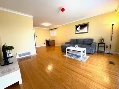a living room with a couch and a table at Cozy Stay, Self Check-In with Parking available upon request in Toronto
