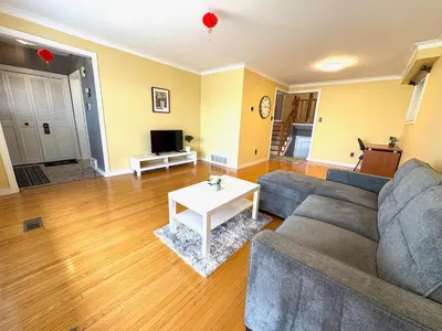 a living room with a couch and a table at Cozy Stay, Self Check-In with Parking available upon request in Toronto