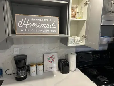a kitchen counter with a sign that says happiness is homemade with love and butter at Beautiful and cozy unit in Mississauga