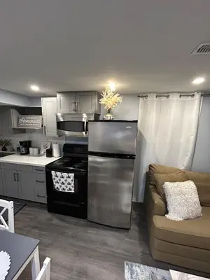 a kitchen with a stove and a couch at Beautiful and cozy unit in Mississauga