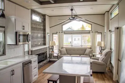 a kitchen and living room with a couch and a table at Scugog Landing Resort in Port Perry