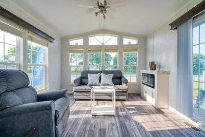 a living room with a couch and a table at Scugog Landing Resort in Port Perry