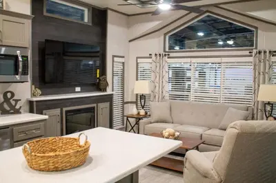 a living room with a couch and a table at Scugog Landing Resort in Port Perry