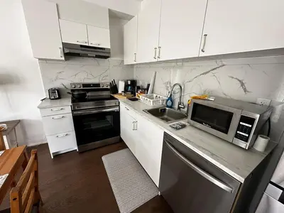 a kitchen with white cabinets and a stainless steel appliance at Brand New 2 Storey Unit With A Free Parking Space in Richmond Hill