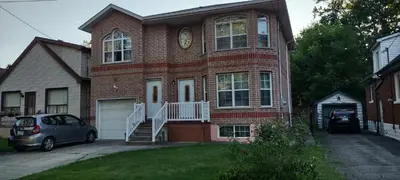 a house with a car parked in front of it at 2 bdrm apartment 3 min walk to McMaster University in Hamilton