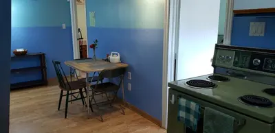 a kitchen with a green stove and a table at 2 bdrm apartment 3 min walk to McMaster University in Hamilton