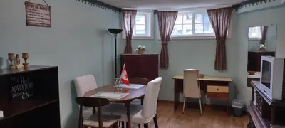 a dining room with a table and chairs and a desk at 2 bdrm apartment 3 min walk to McMaster University in Hamilton