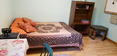 a room with a bed with pillows on it at 2 bdrm apartment 3 min walk to McMaster University in Hamilton
