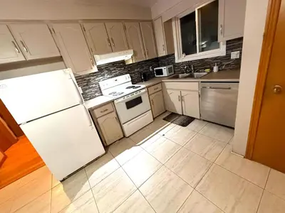 a kitchen with white appliances and a white refrigerator at LONG WEEKEND BUMPER OFFER- Transit,Airport,Downtown Minutes Drive in Kitchener