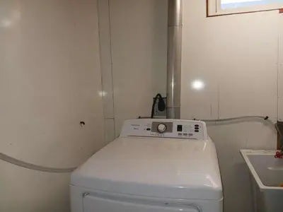 a small bathroom with a toilet and a sink at LONG WEEKEND BUMPER OFFER- Transit,Airport,Downtown Minutes Drive in Kitchener