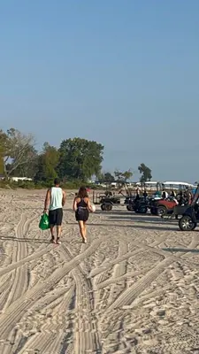 a couple of people walking on the beach at Sherkton Shore Resort in Port Colborne