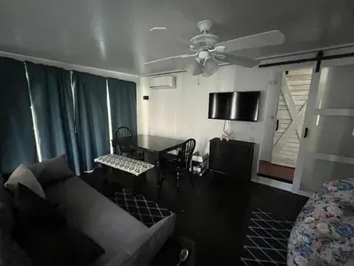a living room with a couch and a ceiling fan at Sherkton Shore Resort in Port Colborne