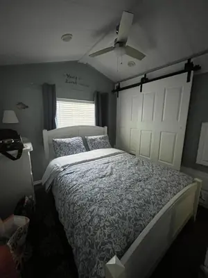 a bedroom with a bed and a white door at Sherkton Shore Resort in Port Colborne