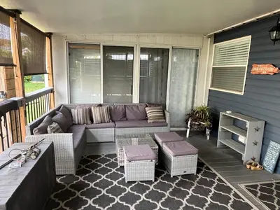 a living room with a couch on a porch at Sherkton Shore Resort in Port Colborne