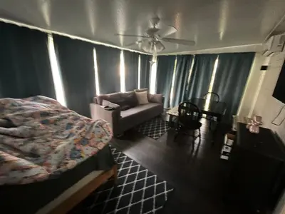 a living room with a bed and a couch at Sherkton Shore Resort in Port Colborne