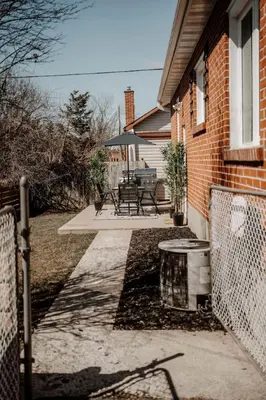 a porch of a house with chairs and a fence at The Barrie Nook in Barrie