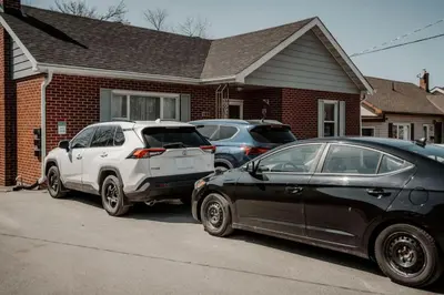 three cars parked in front of a house at The Barrie Nook in Barrie
