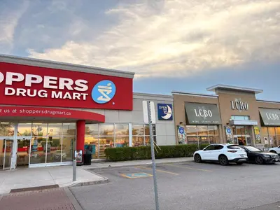 a store front of a drug mart with cars parked in a parking lot at Vita House - Rogers Stadium and Yorkdale Mall Toronto - quiet and cozy bedrooms in Toronto