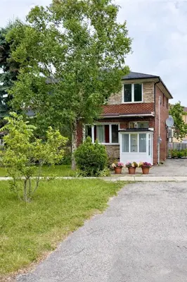 a brick house with a tree in front of it at Vita House - Rogers Stadium and Yorkdale Mall Toronto - quiet and cozy bedrooms in Toronto