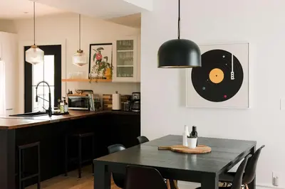 a kitchen with a table with a record on the wall at SquirrelHaus PEC in Hillier