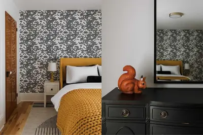 a bedroom with a bed and a mirror on a dresser at SquirrelHaus PEC in Hillier